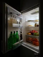 Open_refrigerator_with_food_at_night.webp